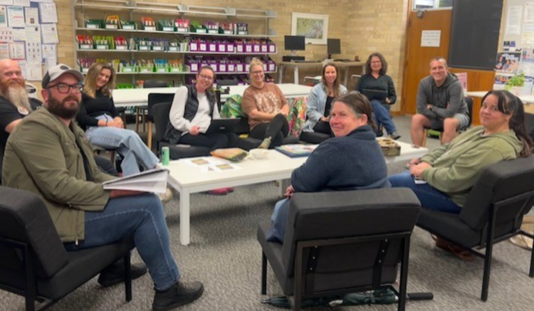 P & C meeting in the school staff room. Parents are seated in a circular setting around a low table.